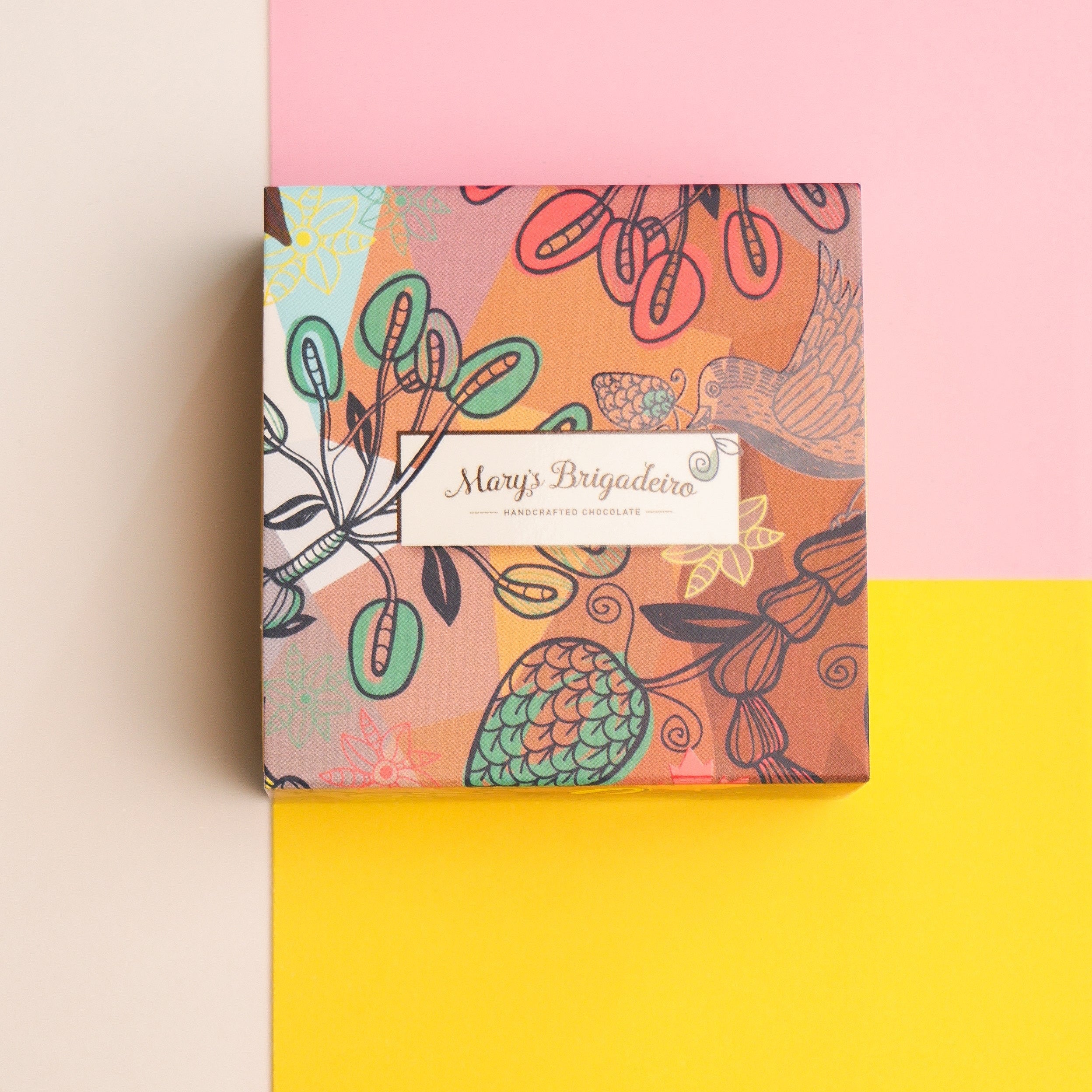 Box of assorted 4 pieces Brigadeiro chocolates with a decorative box on a colorful background