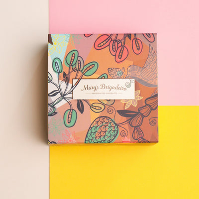 Box of assorted 4 pieces Brigadeiro chocolates with a decorative box on a colorful background